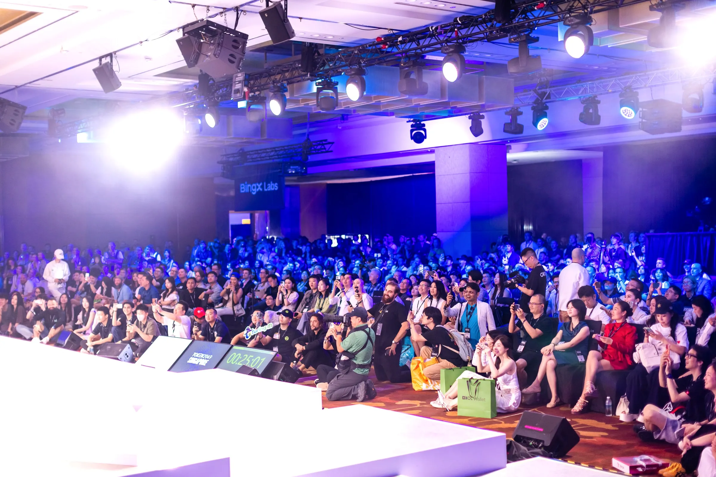 Wide view of the hall, lighting rig overhead and the crowd running back