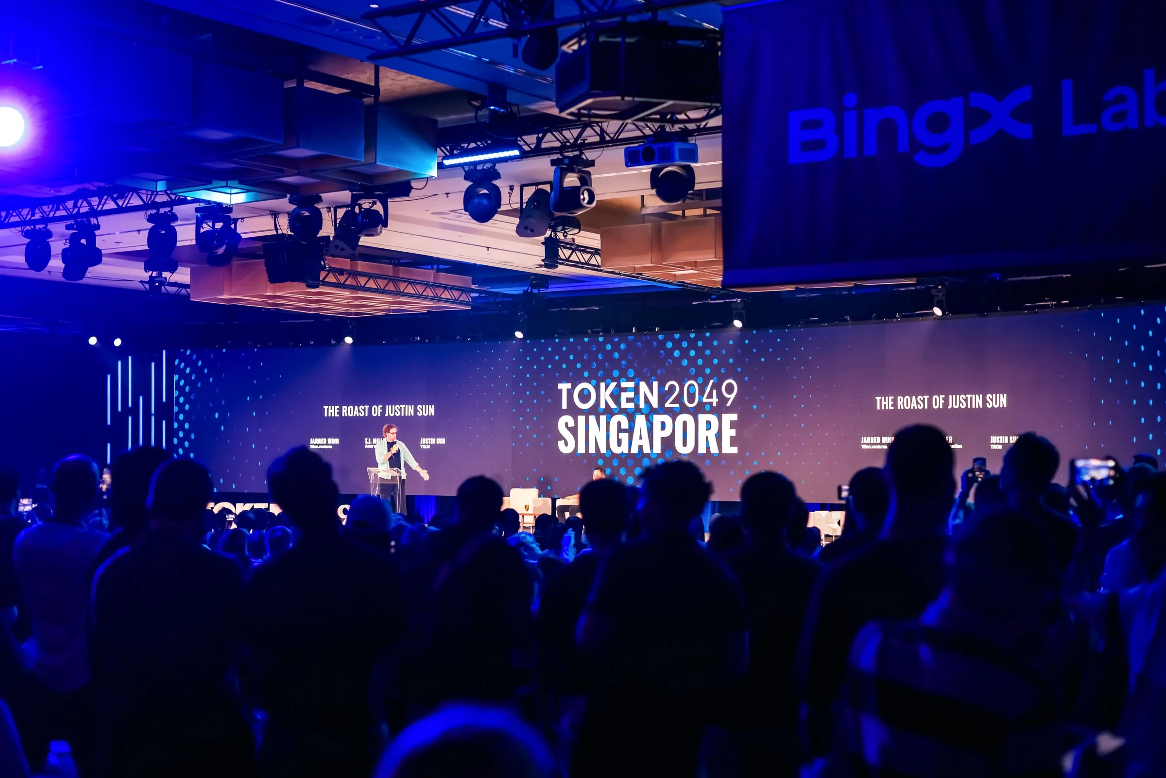 The roast title and billing on the main Token2049 LED wall
